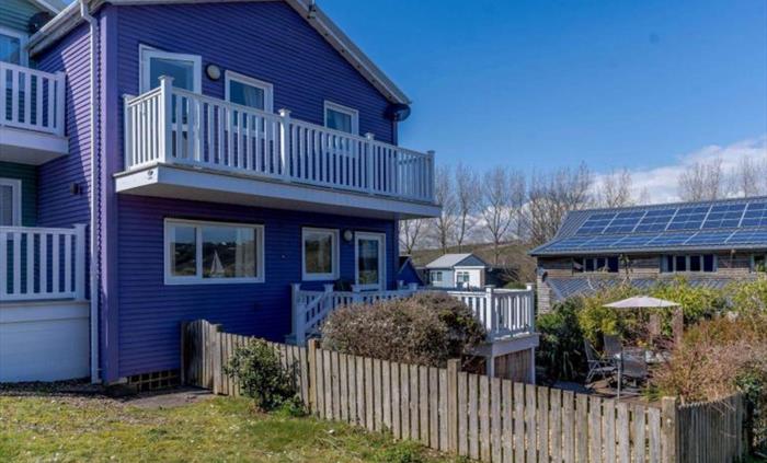 side View of the house showing the front garden and the lower and upper decks.